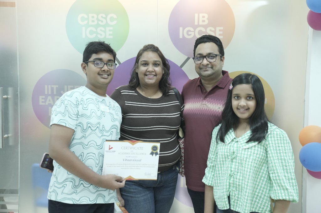 Catalyst Classes student with family holding an academic excellence certificate